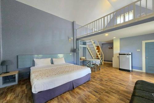 a bedroom with a large bed and a staircase at Doi Tung View Resort in Mae Sai