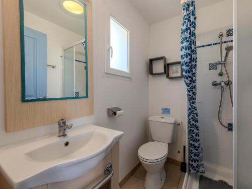 a bathroom with a sink and a toilet and a mirror at T de Pentrez N53 3P6 in Pentrez