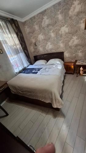 a bedroom with a bed in a room at Viktoriahotel in Tbilisi City
