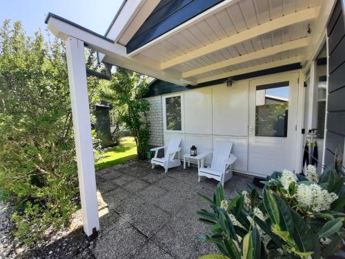 a patio with two chairs and a table at Bungalow 024 in Petten