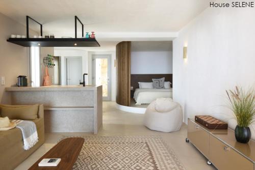 a living room with a bedroom and a bed at KYNARA Boutique Village in Tinos Town