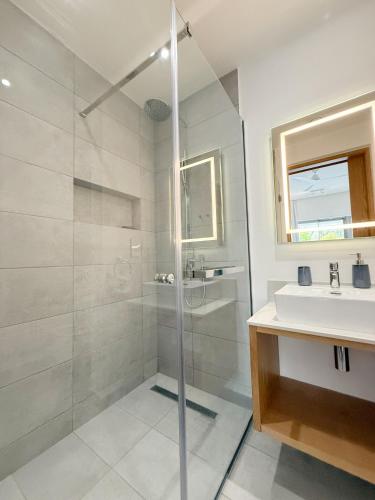 a bathroom with a shower and a sink at Ki Resort Apartments & Penthouses by LOV Mauritius in Grand-Baie