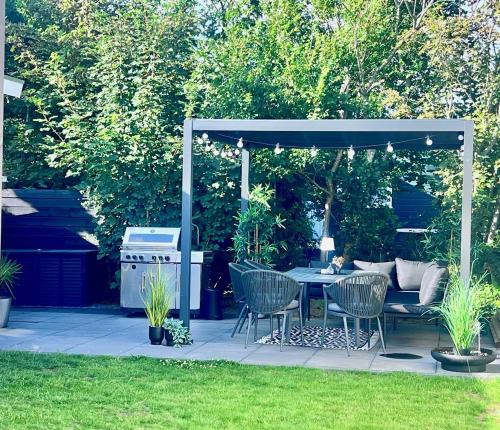 a patio with a table and chairs under a gazebo at Chalet 5 in Petten