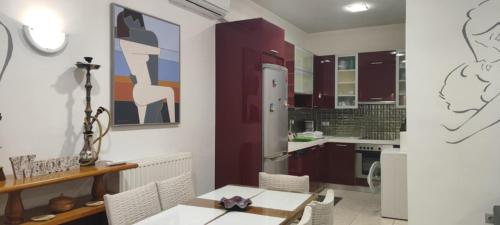 a kitchen with a table and a dining room at Art house M & F in Órion