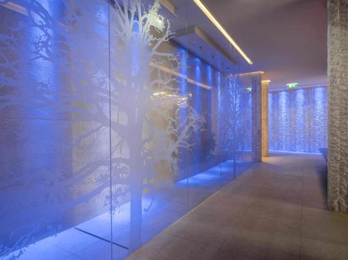 a room with a wall with blue lights on it at first mountain Hotel Montafon in Gaschurn