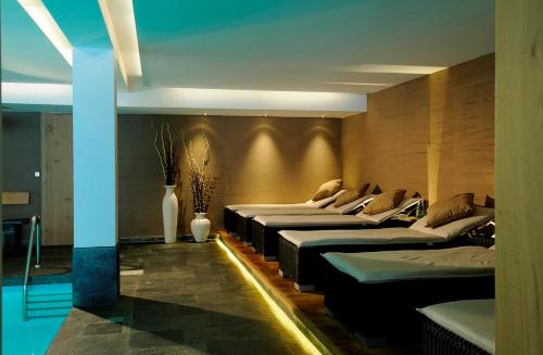 a row of beds lined up in a room at first mountain Hotel Montafon in Gaschurn