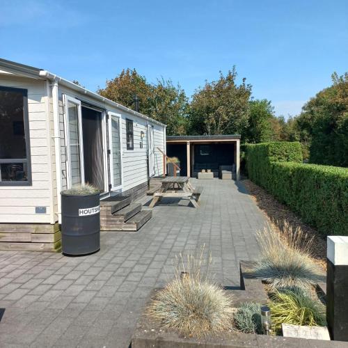 eine Terrasse vor einem Haus mit einem Mülleimer in der Unterkunft J 217 in Petten