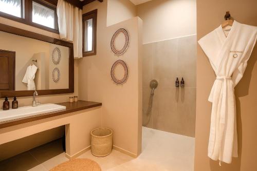 a bathroom with a sink and a shower at Diamonds Mapenzi Beach in Kiwengwa