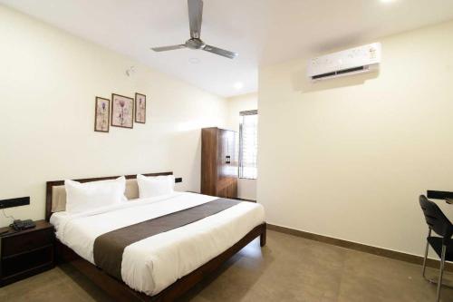 a bedroom with a bed and a ceiling fan at Townhouse Oak NFC Crossway Hyderabad in Maula Ali