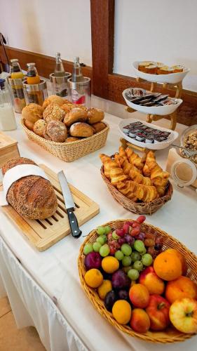 a table with many different types of bread and pastries at Weinhaus Hotel zum Josefshof in Graach