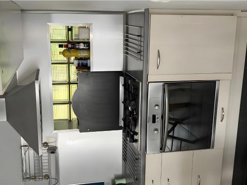 a kitchen with white cabinets and a stove top oven at Le Tertre Camillac in Saint-Seurin-de-Bourg