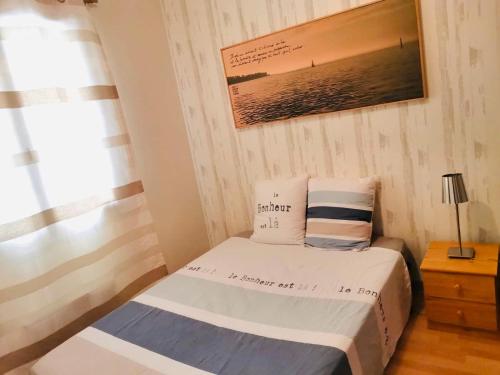 a small bedroom with a bed and a window at Le Tertre Camillac in Saint-Seurin-de-Bourg