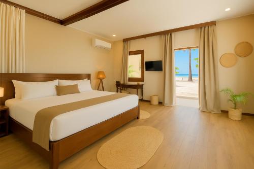 a bedroom with a bed and a sliding glass door at Diamonds Mapenzi Beach in Kiwengwa