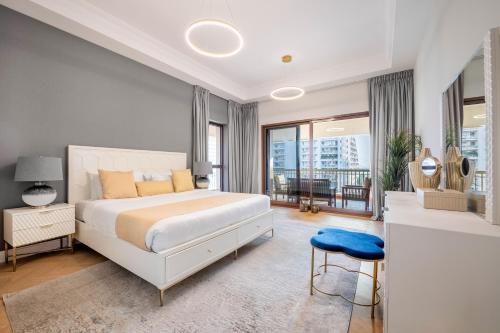 a bedroom with a large bed and a balcony at Ultra Luxury Palm - Free 5-star Beach Resorts Access in Dubai