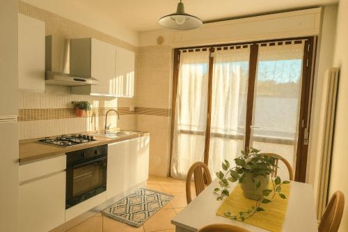 a kitchen with a table and a sink and a window at Gabry's Holiday Apartment in Ortona