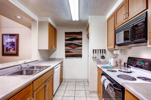a kitchen with a sink and a stove at Evergreen Condominiums by Keystone Resort in Keystone