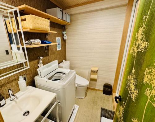 a small bathroom with a toilet and a sink at Ueno Touganeya Hotel in Tokyo