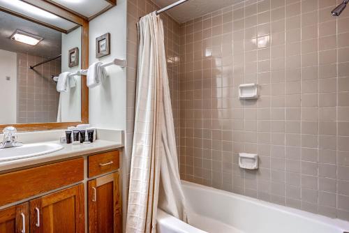a bathroom with a tub and a sink and a shower at Evergreen Condominiums by Keystone Resort in Keystone