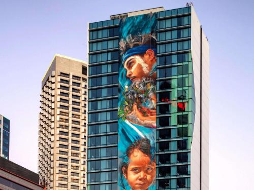 a building with a large mural on the side of it at The Adnate Perth - Art Series in Perth