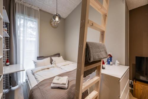 a bedroom with a bunk bed and a tv at Villa Memory-Aurora view bath-Sauna-Lapland-Santa in Rovaniemi