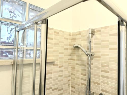 a bathroom with a shower with a glass door at M272 - Marcelli, trilocale con giardino e posto auto in Marcelli