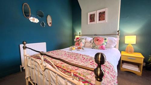 a bedroom with a bed with a white bedspread at Cosy and comfy 2 bedroom cottage with parking to the rear and a short drive from Cannock town centre in Hednesford