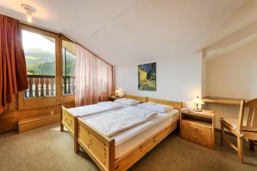 Postel nebo postele na pokoji v ubytování Poschiavo Suisse Hotel