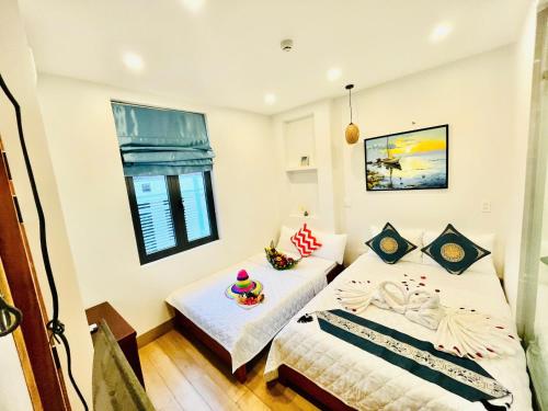 a bedroom with two beds and a window at Homestay Lumia Gold in Quy Nhon