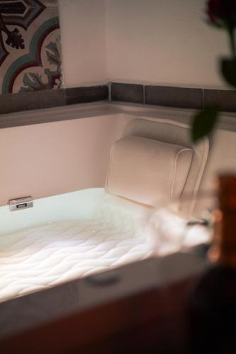 a small white bed in a small room at Novecento Room and Breakfast Puglia in Massafra