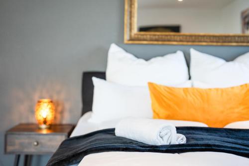a hotel room with a bed with towels on it at 90m2 Loft I Kaffee I Terrasse I E-Parkplatz I 65' Smart TV in Rosenheim