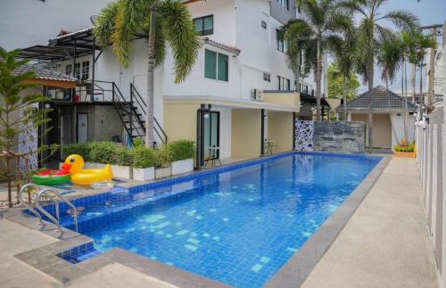 a swimming pool in front of a house at R2 Bed and Pool Kanchanaburi in Kanchanaburi City