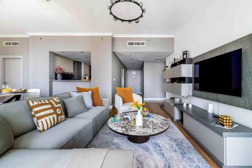 a living room with a couch and a table at Frank Porter - Burj Vista 1 in Dubai
