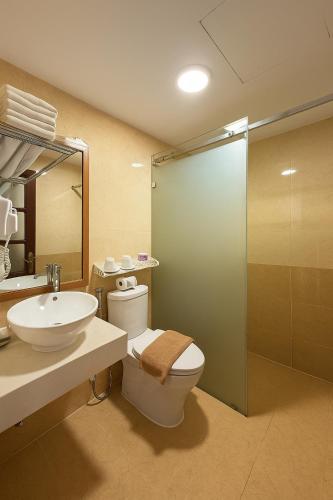a bathroom with a toilet and a sink and a shower at Splendid Star Boutique Hotel in Hanoi