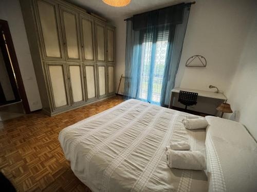 a bedroom with a large bed and a large window at Paolo&SilviaHost in Seriate