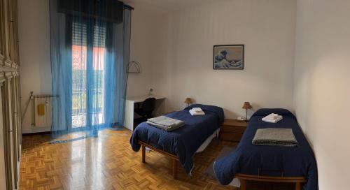 a bedroom with two beds and a television in it at Paolo&SilviaHost in Seriate
