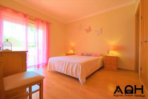 a bedroom with a bed and a large window at Luz do Sol in Guia
