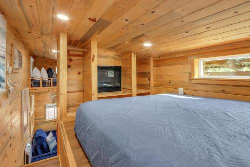 a bedroom with a bed in a wooden cabin at Arbor House of Dripping Springs - Serenity Hollow in Dripping Springs