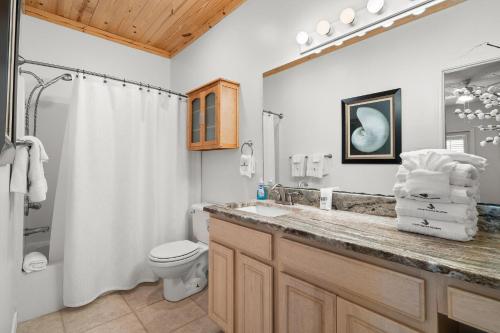 a bathroom with a sink and a toilet and a shower at Charter Landing A7 in Orange Beach