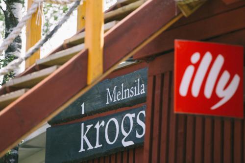 a kroos sign on the side of a building at Viesu nams Melnsils in Melnsils