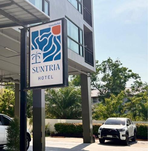 a sign for a hotel in front of a building at Suntria Hotel Pattaya in Na Jomtien