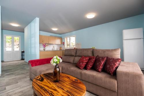 a living room with a couch and a table at Casa Vale Sereno by Rent-a-key in Cabo da Ribeira