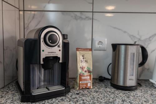 a coffee maker and a coffeemaker on a counter at Casa Vale Sereno by Rent-a-key in Cabo da Ribeira