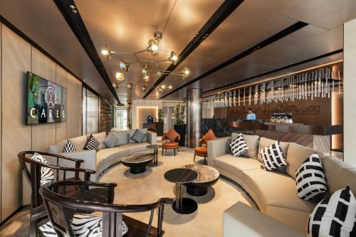 a lobby with couches and tables and a bar at Citadines Connect Bertam Georgetown Penang in George Town