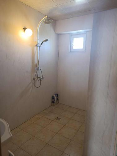 a bathroom with a shower and a tiled floor at стаи за настаняване in Razgrad