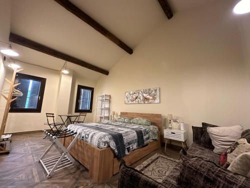 a room with a bed and a couch in it at Il Correggiolo in Argenta