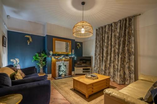 a living room with a couch and a table at Shorethwaite in Amble