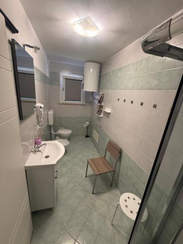 a bathroom with two toilets and a sink and a sink at Il nido delle rondini in Comacchio