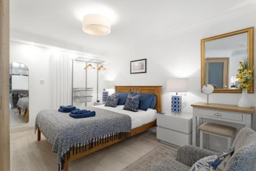 a bedroom with a bed and a mirror at Fisherbeck Nest in Ambleside