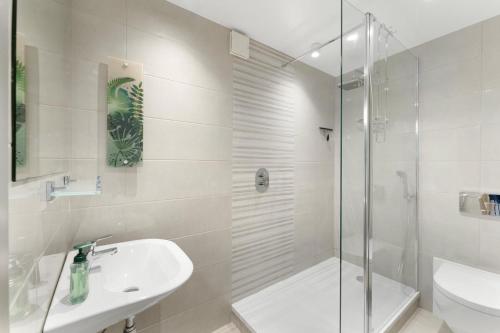a bathroom with a shower and a sink and a toilet at Fisherbeck Nest in Ambleside