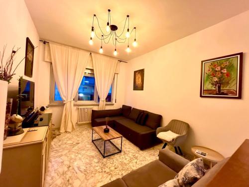 a living room with a couch and a table at Bilocale Golf One Bedroom & Living Room with Sofa Bed in Rapallo